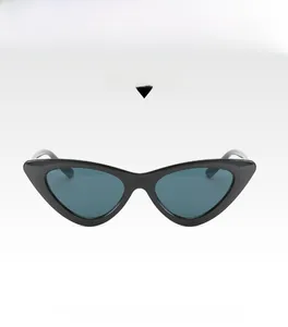 Detail view of retro cat-eye sunglasses with glossy black frames and dark lenses