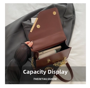 Detail view of the brown leather crossbody bag showing internal storage capacity
