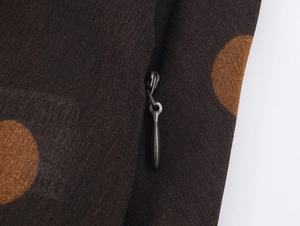 Detailed macro view of the invisible zipper closure on the polka dot georgette fabric