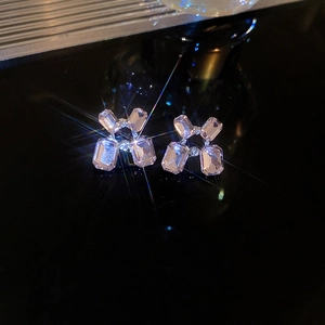 Macro view of crystal geometric flower earrings with silver studs and starburst effect