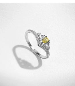 Macro detail of crown ring with pear-cut yellow gemstone and sparkling small diamonds