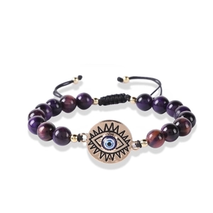 Detailed macro view of the Evil Eye charm on a natural stone beaded bracelet