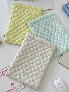 Quilted diamond pattern laptop sleeve in pastel green, light blue, and beige colors