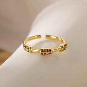 Macro shot of gold-plated open ring featuring red and black micro-pave crystals