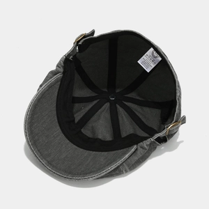Detailed interior view of 100% cotton washed grey beret showing metal buckle and lining