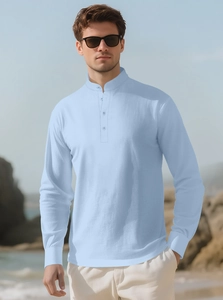 Detail of light blue linen shirt featuring a neat buttoned Henley collar and breathable texture