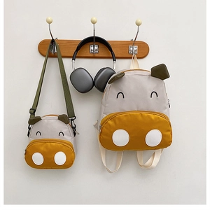 Close-up of cute cartoon canvas backpack set with 3D animal ears and embroidery