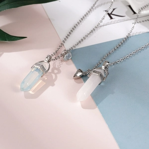 Detail of magnetic heart clasp connecting two hexagonal crystal bullet pendants