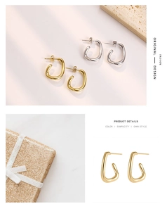 Close-up of minimalist C-shape curved metal earrings in polished gold and silver finishes