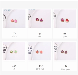 Macro view of square crystal charms in varied colors with golden bird nest claw setting