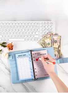 Detail view of A6 budget binder with 100-day savings challenge tracker and dry-erase pen