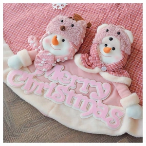 Close-up of pink Christmas tree skirt featuring plush snowmen and red checkered patterns