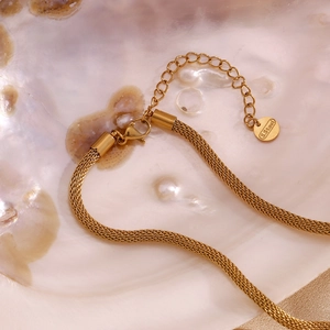 Detail of 18K gold plated stainless steel mesh chain with lobster clasp and tag