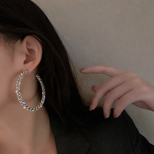Elegant oversized silver hoop earrings with full pave rhinestones on female model
