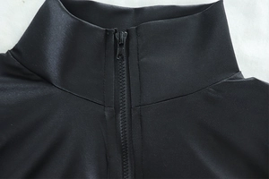 Detail of the high-quality zipper closure and stand collar on the black yoga tracksuit