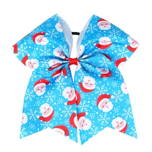 Detail of light blue Christmas hair bow with Santa prints and durable elastic band