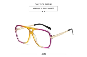 Side view of retro oversized sunglasses with purple and yellow gradient lenses and gold temples