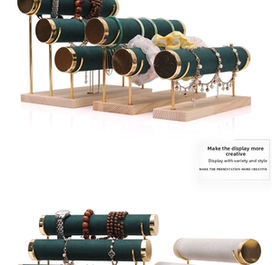 Detail view of T-bar velvet jewelry stands with gold metal poles and wooden bases