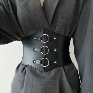 Women's black corset belt with three silver rings over a grey textured blazer