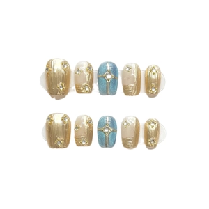 Handmade press-on nails set with vintage gold textures and starry blue glitter designs