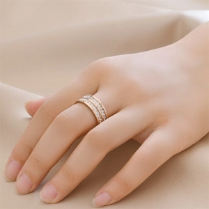 Three-layer rose gold titanium ring with zircon crystals shown on model's hand