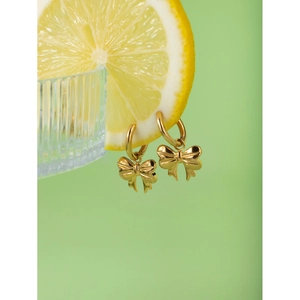 Fashionable 18k gold stainless steel bow earrings displayed on a fresh lemon slice