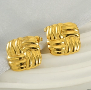 Macro detail of square woven texture earrings in 18k gold-plated stainless steel finish
