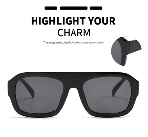 Detailed view of large square flat top sunglasses with glossy black frames and dark lenses