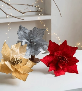 Detailed macro of gold, red, and silver glitter poinsettia flowers for Christmas tree decor