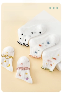 Detail of breathable mesh baby socks with cute cartoon prints and ruffle trim edges
