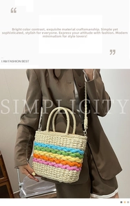 Detailed macro view of woven rainbow stripes and dual-handle texture on the straw tote bag