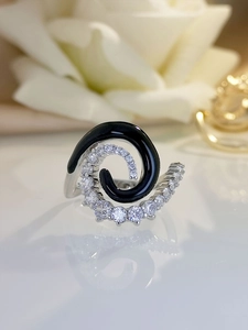 Detail shot of spiral ring with black enamel and sparkling cubic zirconia stones