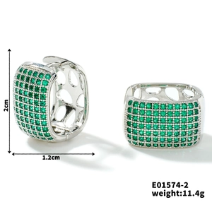 Detailed view of silver square hoop earrings featuring pavé green zircon stones