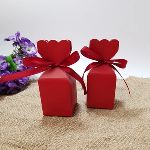 Detail of red striped gift boxes with ribbon and heart-shaped closure for candy