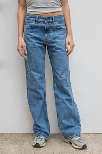 Close-up of vintage washed blue denim fabric and classic five-pocket detail on jeans
