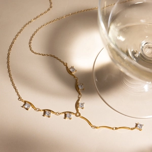 Détail du collier en Y en acier inoxydable doré 18 carats avec six zircons carrés