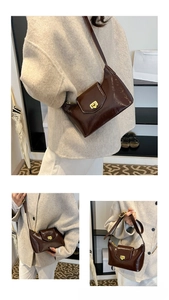 Detail view of glossy dark brown PU leather shoulder bag with gold metal buckle clasp