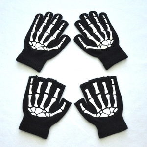 Flat lay of knitted skull bone print gloves in full-finger and half-finger styles