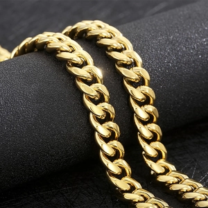 Macro shot of 12mm gold-plated Cuban link chain showing polished heavy metal texture
