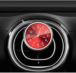 Detail of red car dashboard clock with silver alloy frame and luminous quartz movement