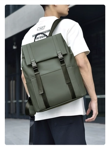Olive green matte waterproof backpack with flap closure shown on model in urban setting