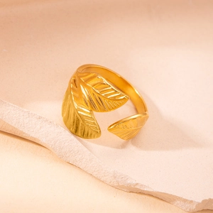 Detailed macro view of a golden leaf-shaped ring with realistic textures and adjustable band
