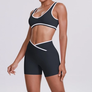 Detail of grey yoga set featuring contrast white binding and cross waist shorts design