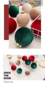 Detail of 8cm velvet Christmas balls in red, green, and beige with golden hanging loops