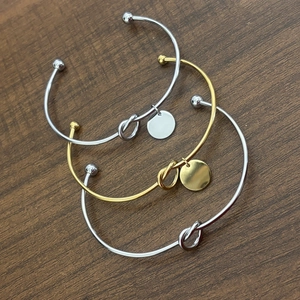Minimalist knot cuff bangle in gold and silver finish with round pendant charm