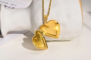 Detailed view of an openable heart-shaped gold locket necklace with a polished finish