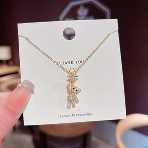Macro view of golden bear pendant with sparkling white zircons and a fine gold chain