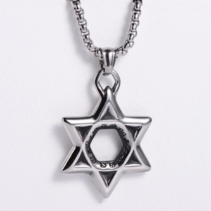 Macro shot of silver stainless steel hexagram pendant with Gothic engraved details
