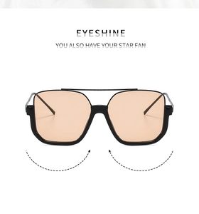Detail view of double bridge sunglasses with square orange lenses and black metal frames