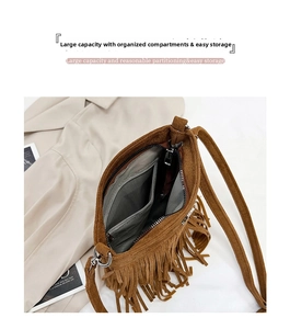 Detail view of the brown suede crossbody bag showing the large capacity inner compartments